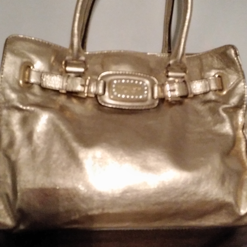 Michael Kors gold genuine leather handbag. Crystals embossed on front